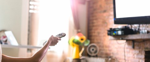 IPTV für Reseller Header Frau sitzt im Sessel und schaut Fernsehen