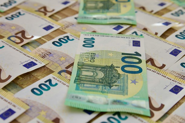 Geld Eine Vielzahl an 200 Euroscheine die geordnet da liegen, auf denen zwei grüne 100 Euroscheine liegen
